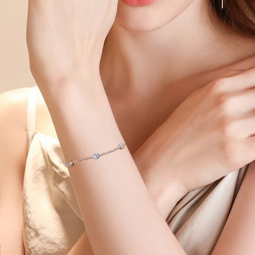 Women's delicate silver chain bracelet with bezel-set round brilliant clear stones on arm