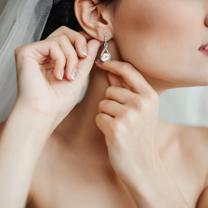 Pearl And Cubic Zirconia Infinity Dangle Earrings