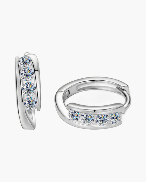 Two women's silver huggie hoop earrings with five round brilliant-cut moissanite stones each