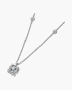 Women's silver chain necklace with a round solitaire pendant and bezel-set accent stones