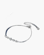 Elegant women's silver 925 bracelet with five sparkling cubic zirconia stones on blue background