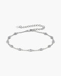 Elegant women's silver 925 bracelet with bezel-set cubic zirconia stones on a light background