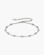 Elegant women's silver 925 bracelet with bezel-set cubic zirconia stones on a light background
