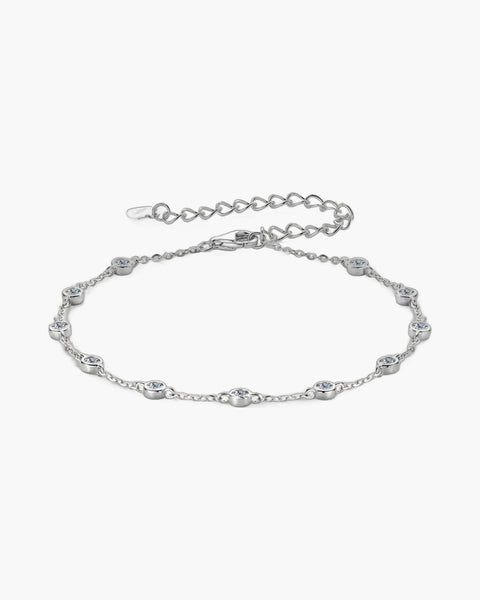 Elegant women's silver 925 bracelet with bezel-set cubic zirconia stones on a light background