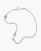 Women's sterling silver bracelet with a sideways cross charm and a single round diamond