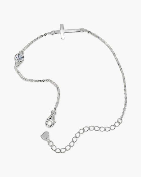 Women's sterling silver bracelet with a sideways cross charm and a single round diamond