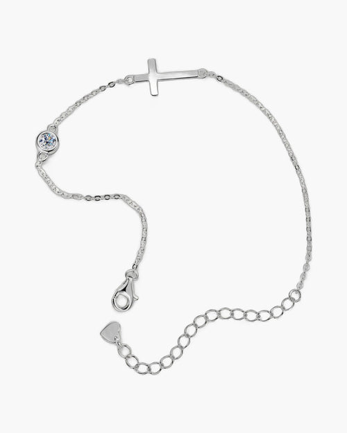 Women's sterling silver bracelet with a sideways cross charm and a single round diamond