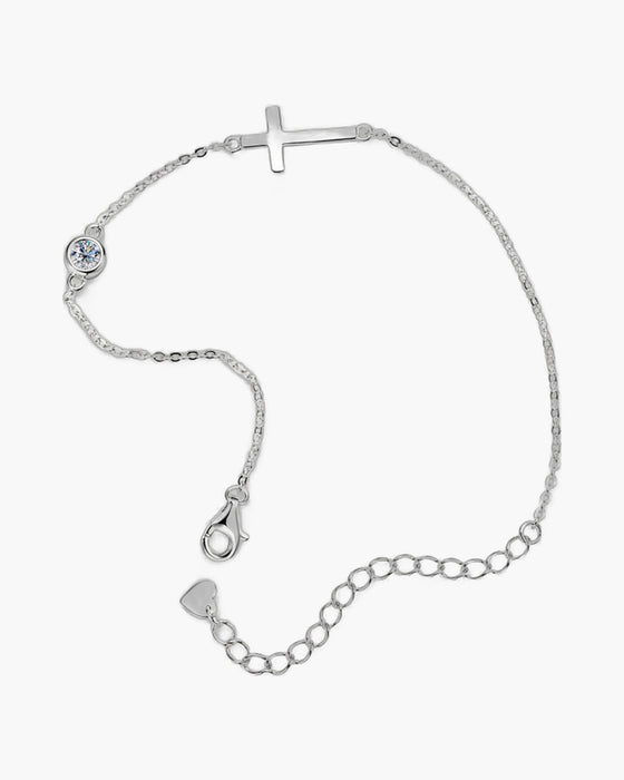 Women's sterling silver bracelet with a sideways cross charm and a single round diamond