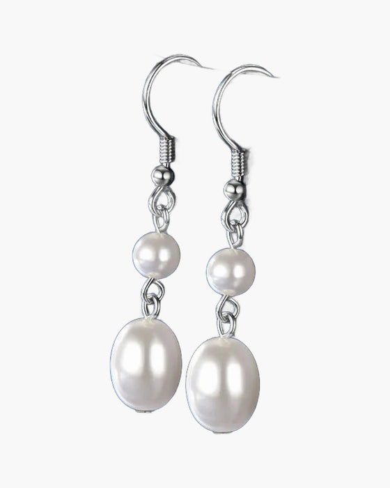 Elegant women's silver 925 dangle earrings featuring lustrous white freshwater pearls on a blue background