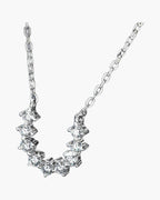 Women's delicate silver 925 necklace with sparkling cubic zirconia stones on a blue background