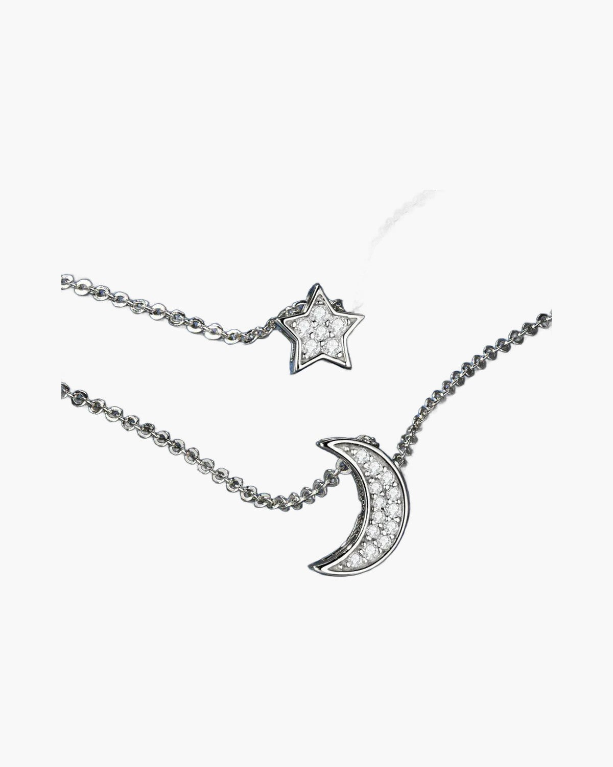 Sparkling silver women's necklaces with star and moon pendants on a blue background