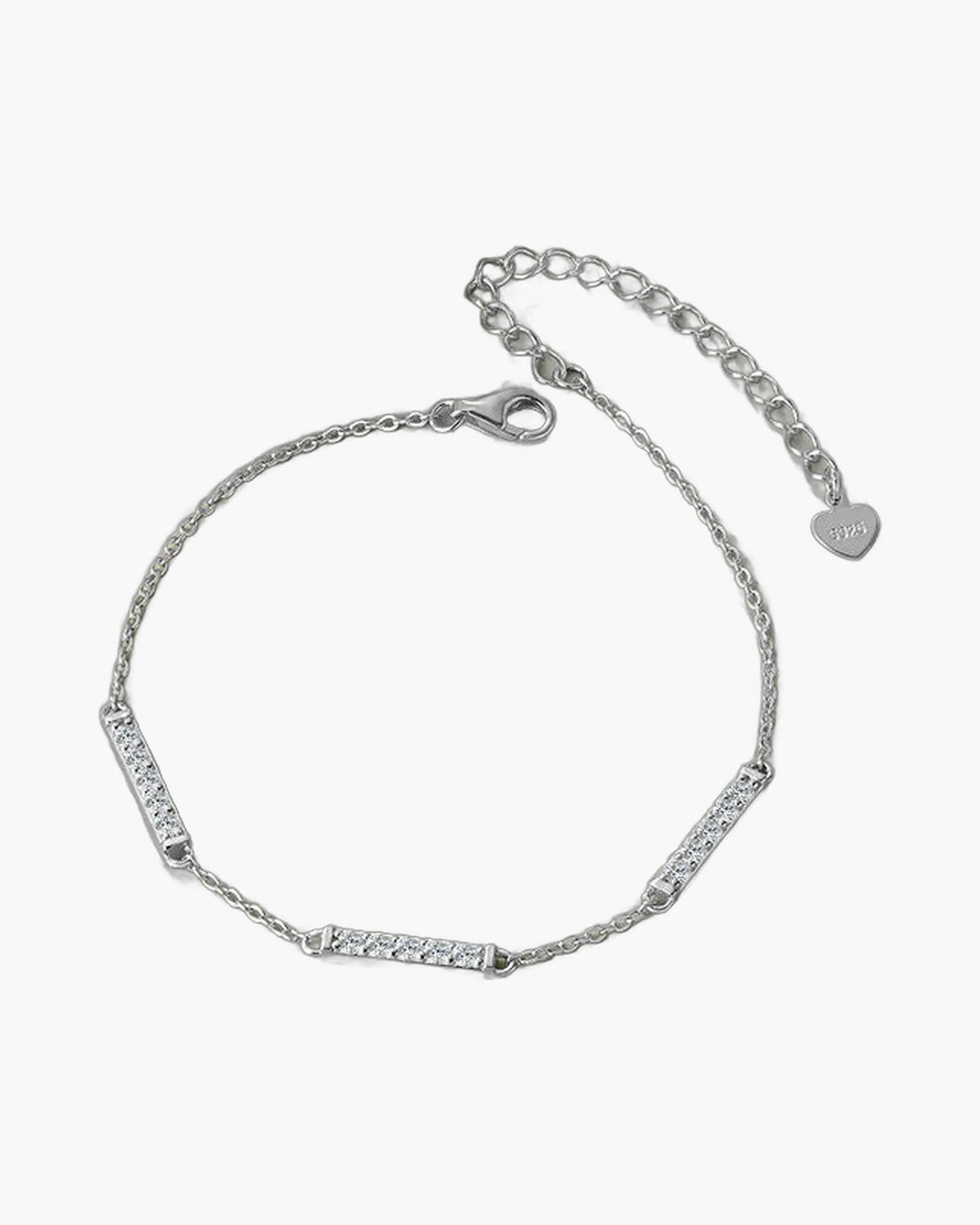 Delicate women's silver 925 bracelet with sparkling cubic zirconia bar links on green surface