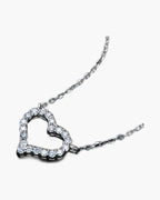 Sparkling women's silver 925 heart pendant necklace with brilliant cubic zirconia stones on black background