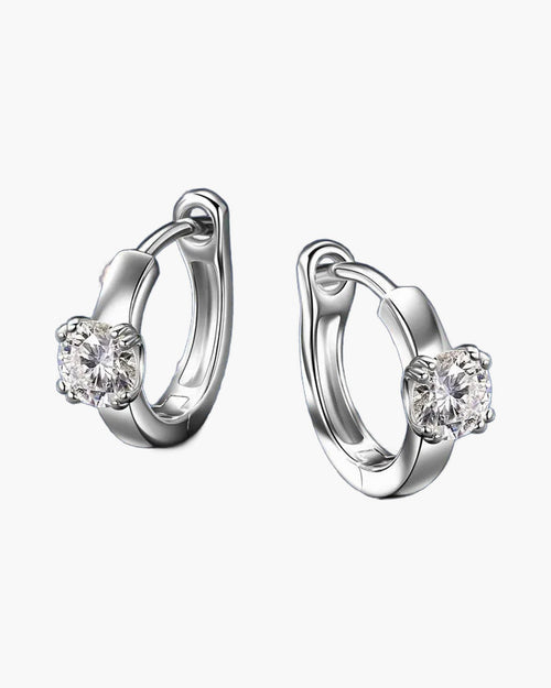 Pair of women's silver huggie hoop earrings with a single round moissanite stone
