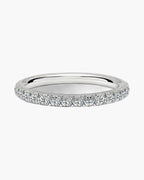 Elegant women's silver ring with a row of sparkling diamonds on a white background