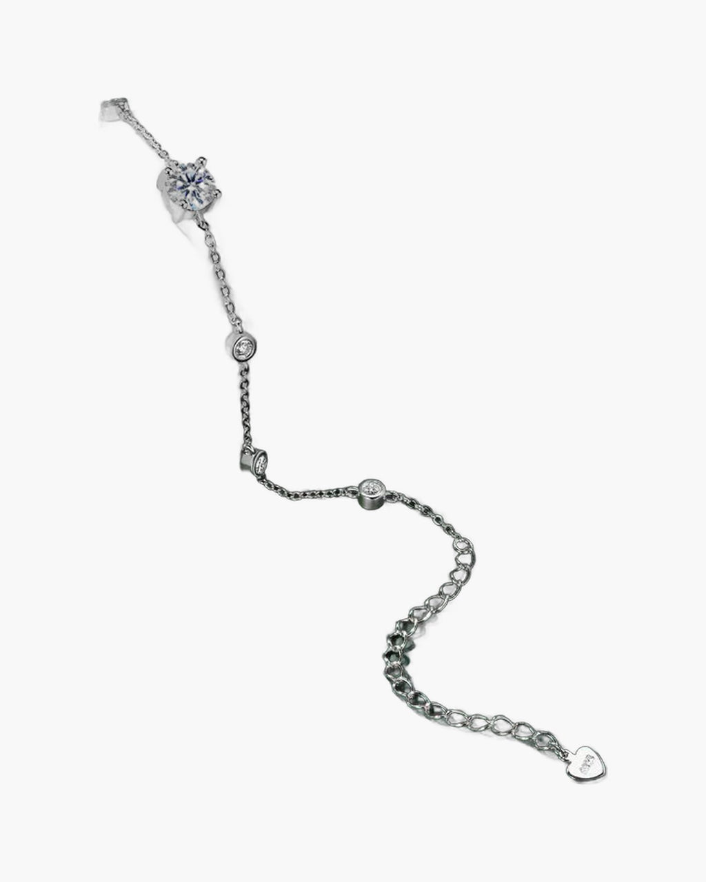 Women's delicate silver 925 bracelet with sparkling cubic zirconia stones on a dark green surface