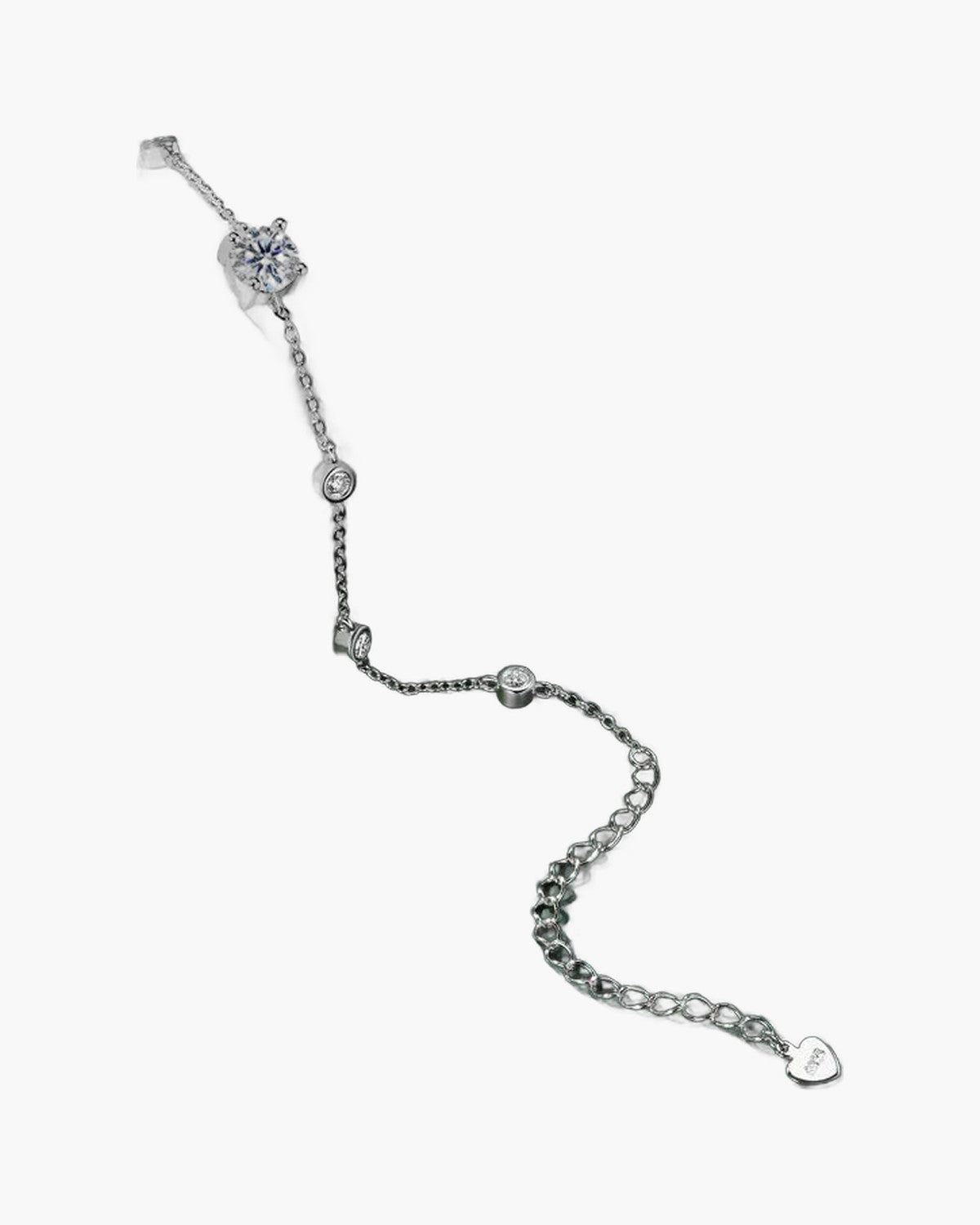 Women's delicate silver 925 bracelet with sparkling cubic zirconia stones on a dark green surface
