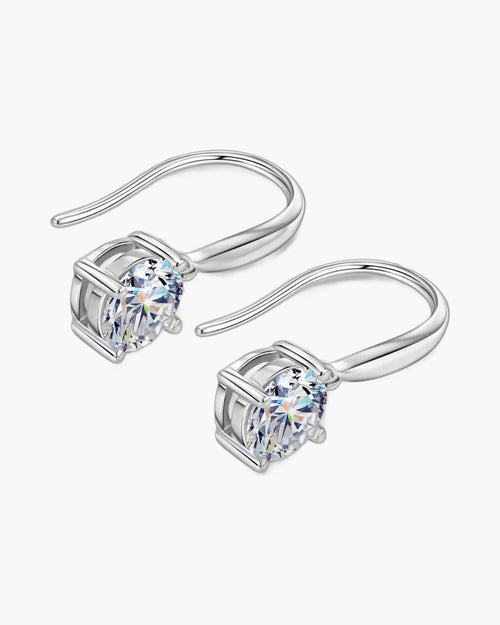 Pair of women's silver dangle earrings with brilliant round solitaire moissanite stones