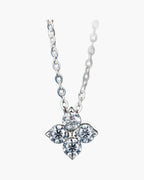 Women's silver 925 chain necklace with a sparkling four-stone clover pendant on blue background
