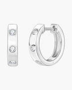 Women's silver 925 huggie hoop earrings with bezel-set round brilliant moissanite stones