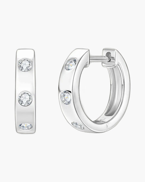 Women's silver 925 huggie hoop earrings with bezel-set round brilliant moissanite stones