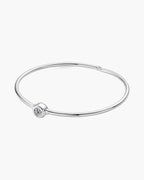 Sleek women's silver 925 bangle bracelet with a single bezel-set round diamond