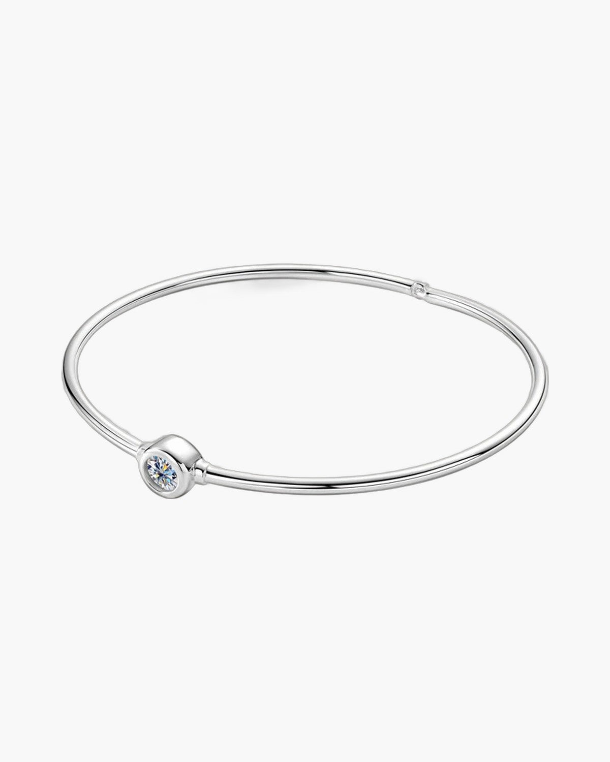 Sleek women's silver 925 bangle bracelet with a single bezel-set round diamond