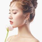Elegant women's silver 925 drop earrings with sparkling cubic zirconia on a model