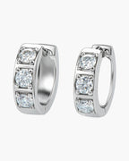 Pair of women's silver hoop earrings with three sparkling round cubic zirconia stones
